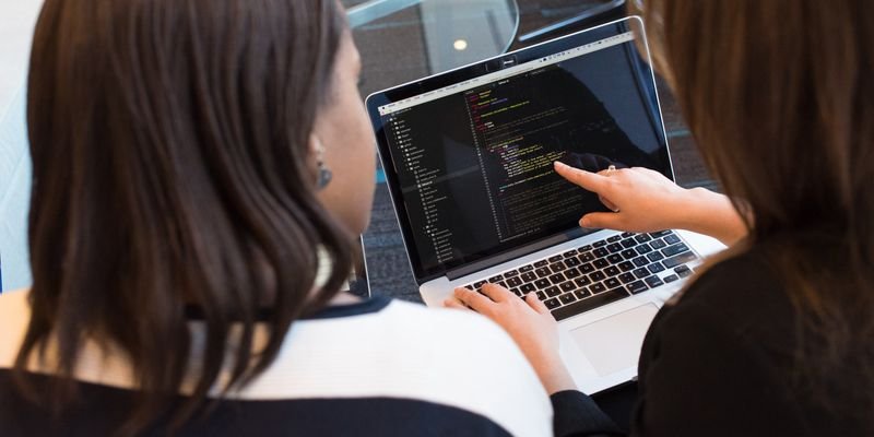 Developer building web platform on laptop